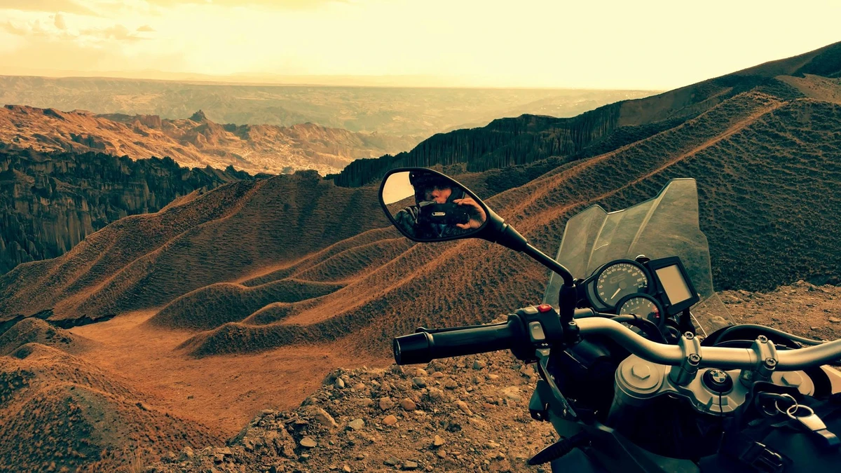 BMW mirror selfie — photographer reflected in canyon landscape